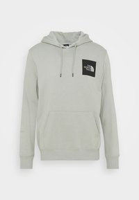 Sudadera gris claro hecha de una tela suave, con un bolsillo delantero tipo canguro, capucha con cordón y un cuadrado de logo negro en el pecho.
