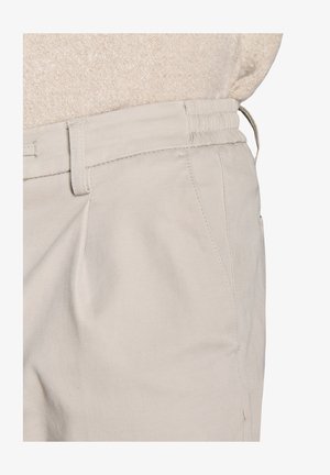 Light beige trousers made of smooth fabric, featuring a fitted waistband with elastic, side pockets, and subtle pleats for added design.