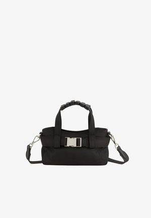 Schwarze Handtasche mit kurzen gepolsterten Griffen, silberner Schnalle vorne und abnehmbarem langem Schulterriemen vor weißem Hintergrund.