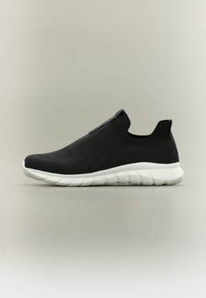 Sort slip-on sneaker med åndbar strikket overdel og hvid polstret sål, designet til let komfort og nem påklædning.