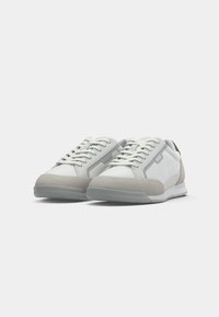 Pair of white and gray lace-up sneakers with "BOSS" logo on side, displayed on a plain white background.