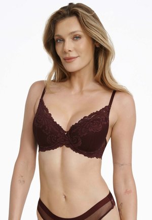 Burgundy lace bra with floral patterns, underwire support, adjustable straps, and scalloped edges. Smooth fabric with a delicate texture.