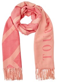 Écharpe rose en tissu doux, présentant un design abstrait avec des rayures rose clair et des bords frangés. Texte : « TOUCHER » en caractères gras.