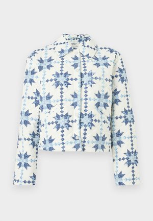 Veste matelassée blanche avec motifs géométriques en forme d'étoiles bleues, boutons-pression, manches longues et col.
