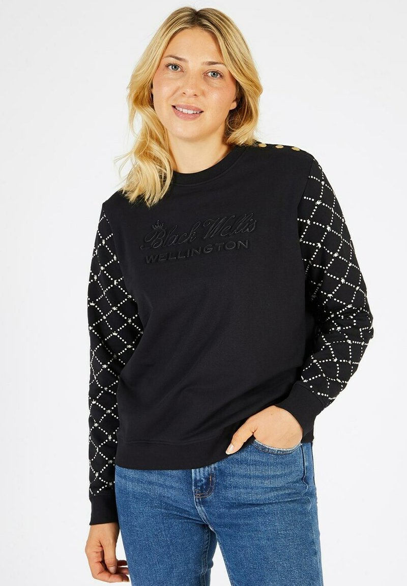 Sweatshirt noir avec devant texturé et détails de logo. Manches longues avec motif en losange et embellissements. Coupe décontractée avec encolure ronde.