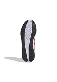 Shoe sole med en svart strukturerad gummibotten, vit mellansula och röda detaljer på den övre delen. Har ett fiskbensmönster för grepp.