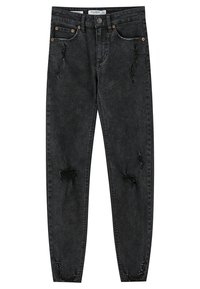 Vaqueros skinny de mezclilla negra con un acabado desgastado, que presentan parches deshilachados y un diseño clásico de cinco bolsillos. Acentos en hardware en tono cobre.