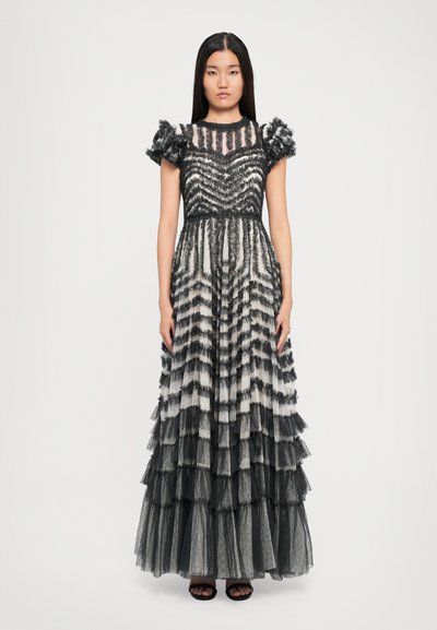 Langes, gestuftes Kleid aus geschichtetem schwarz-weißem Tüll mit Rüschenaermeln und einem gestreiften Muster. Verfügt über ein tailliertes Oberteil und einen fließenden Rock.