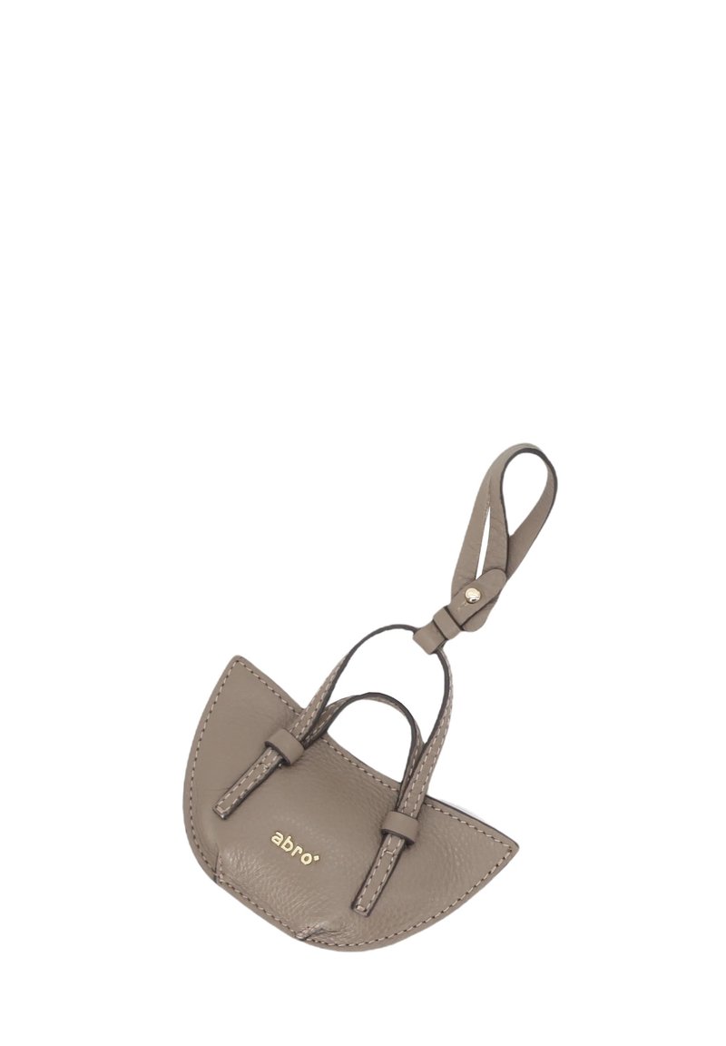 Leather keychain in taupe with a curved, half-moon shape. Features two short handles, gold logo, and contrasting stitching details.