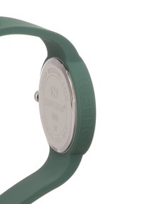 Reloj de silicona verde con una parte trasera de acero inoxidable, resistente al agua hasta 3 ATM, que presenta el nombre de la marca en relieve y una textura suave.