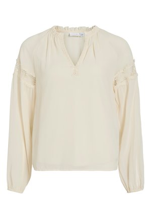 Cream-colored blouse with a V-neck, ruffled neckline, long sleeves, and lace accents on shoulders. Made from lightweight, smooth fabric.