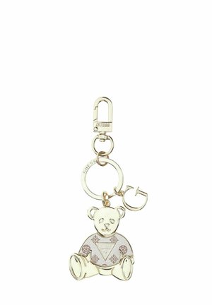 Llavero en tono dorado con un colgante de osito de peluche vestido con una camisa estampada y un colgante con la letra "G", ambos sujetos a un anillo circular y un cierre.
