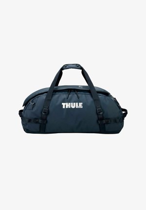 Sac de sport bleu marine Thule avec doubles poignées noires, compartiment principal zippé et sangles latérales réglables, présenté sur fond blanc.