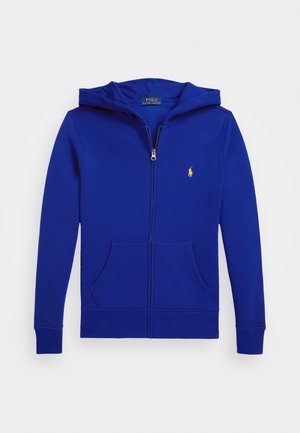 Royal blue zip-up hoodie with a soft texture, kangaroo pockets, and a yellow embroidered logo on the left chest. Features a drawstring hood.
