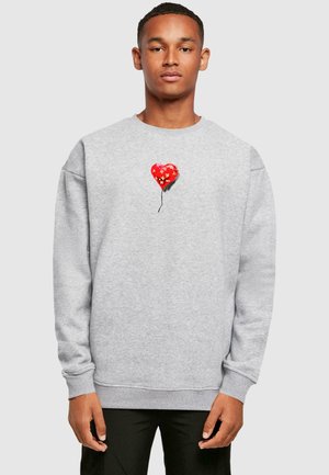 Gray sweatshirt featuring a red heart-shaped balloon graphic with yellow star patterns. Cuffs and hem are ribbed for a textured finish.