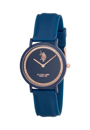 Orologio da polso blu navy con lancette color oro, ghiera tempestata di cristalli, logo U.S. Polo Assn. e cinturino in silicone.