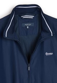 Granatowa kurtka zip-up z kołnierzem stójkowym, z białymi paskami akcentującymi, siateczkowym wykończeniem i haftowanym logo "Diverse" na piersi. Rozmiar X-Large.