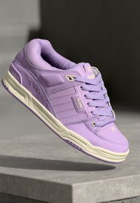 Purple sneaker featuring a smooth synthetic upper, lace-up closure, cushioned tongue, and a textured sole with white accents.