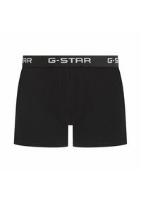 Black boxer shorts made from stretchy fabric. Features a wide elastic waistband with "G-STAR" logo in white, smooth surface with no patterns.