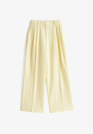 Pantaloni a gamba larga color giallo pallido con pieghe frontali, due tasche laterali e vita aderente. Realizzati in un tessuto leggero.
