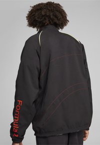 Puma F1 STATEMENT - REVERSIBLE - Fleecejakke - puma black aop