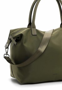 Olive green nylon bag with smooth texture. Features two short handles, a detachable strap, and metallic zipper with pulls. Logo embossed on side.