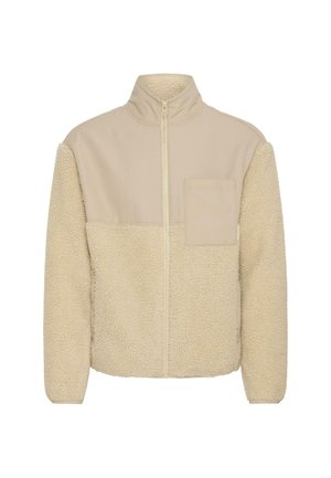 Fleecejakke med høj krave, beige øverste stof og cremefarvet nedre sektion. Har en brystlomme og lynlås lukning. Blød tekstur.