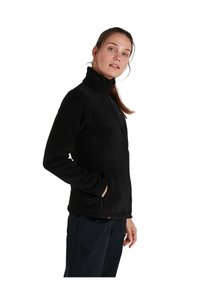 Veste en polaire noire avec un col montant, fermeture éclair à l'avant et poches latérales. Texture lisse et design ajusté, adaptée à une utilisation en extérieur.