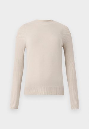 Beige kord genser med lange ermer, ribbet tekstur på skuldrene og mansjettene, rund hals og jevn kroppstekstur. Myk strikket materiale.