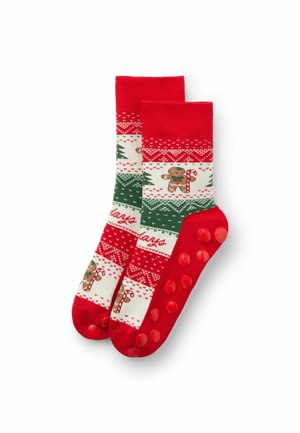Calze a righe rosse e bianche con accenti verdi, design di pan di zenzero e punti antiscivolo sulle suole. Lunghezza corta alla caviglia.