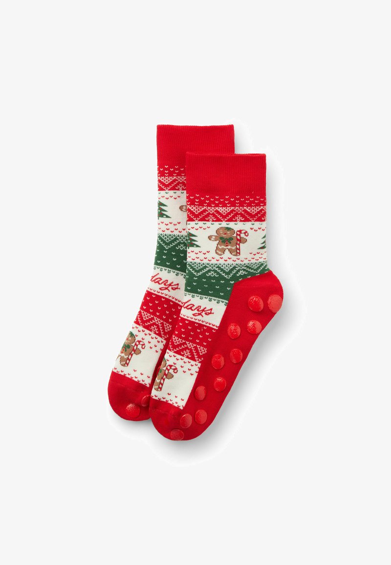 Rot-weiße Socken mit Muster, die grüne Akzente, einen Lebkuchen-Design und rutschfeste Grip-Punkte an den Sohlen haben. Kurze Crew-Länge.