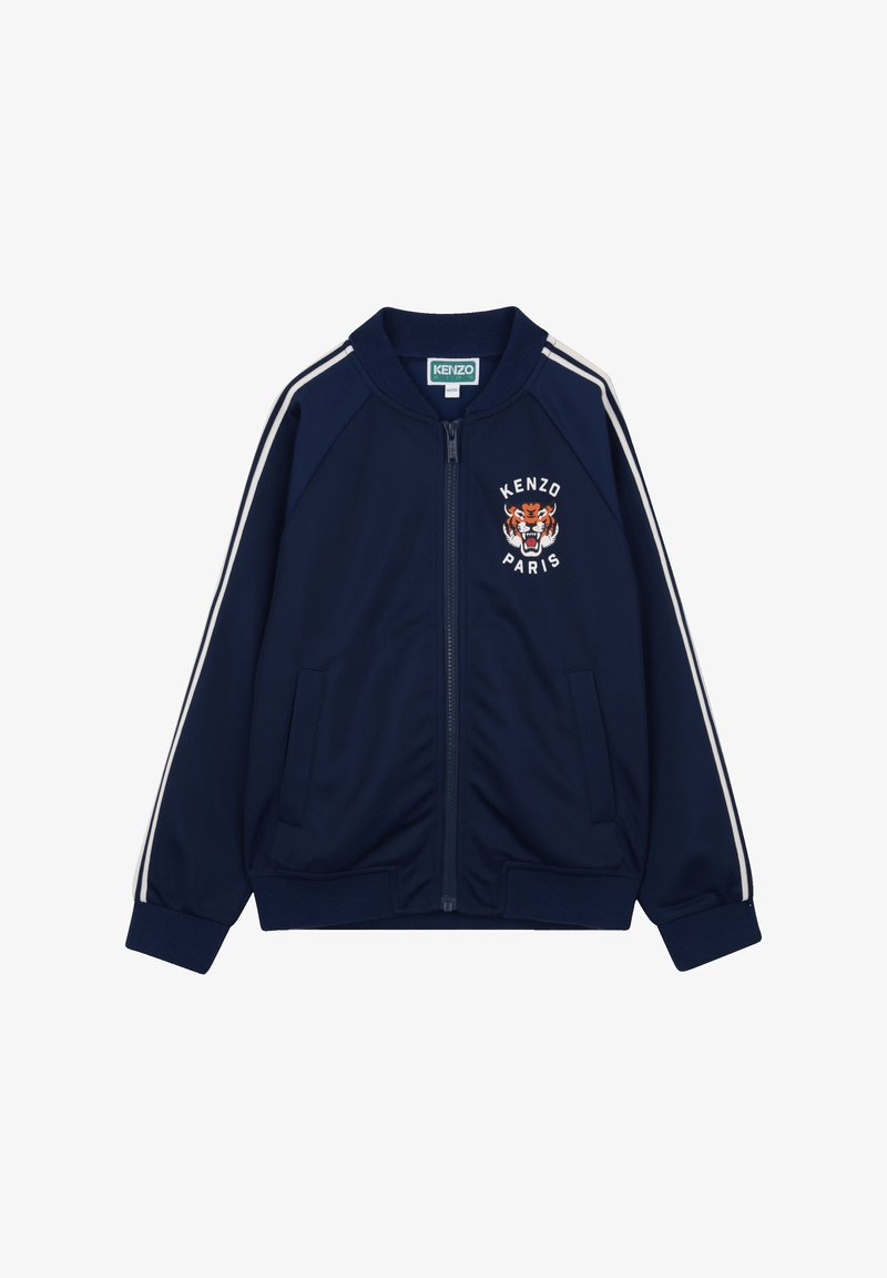 Marineblauw jack met ritssluiting en witte strepen langs de schouders, met een tijgerafbeelding en "KENZO PARIS" borduursel op de borst.