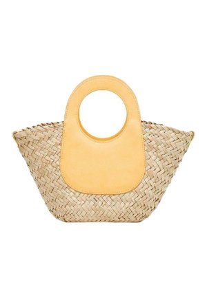 Kudottu olkilaukku, jolla on leveä, pyöreä pohja ja suuri, pyöreä, vaaleanruskea nahkainen kahva keskellä yläosassa.