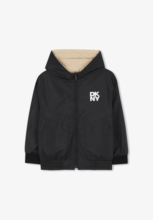 Veste noire à capuche avec fermeture éclair devant, doublure beige, poignets élastiques et deux poches frontales. Présente un logo blanc "DKNY" sur la poitrine.