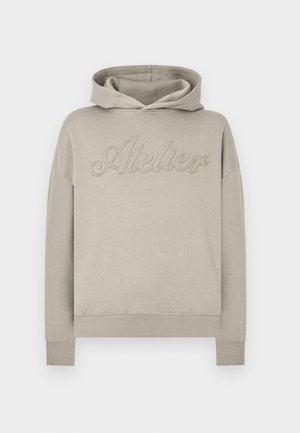 Light gray hoodie made of soft fabric, featuring a front pocket, ribbed cuffs, and the word "Atelier" embossed across the chest.