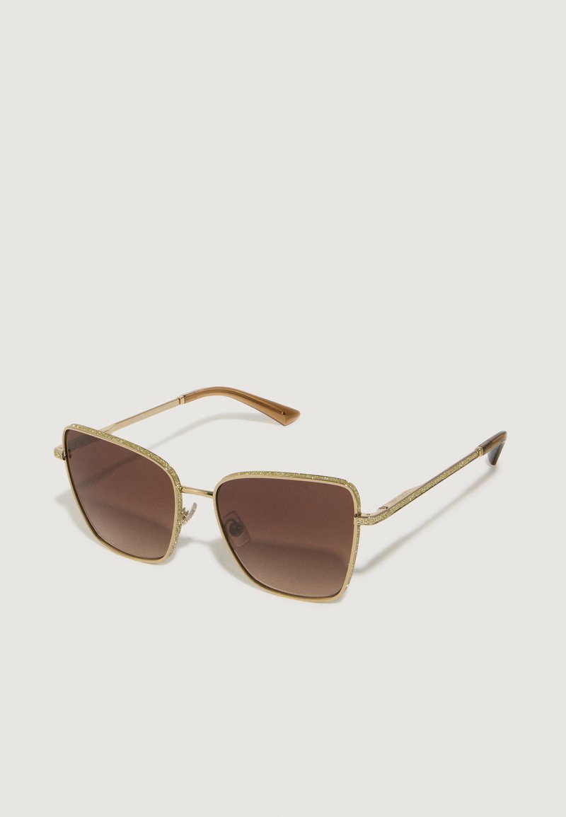 Óculos de sol quadrados em tom de dourado com lentes castanhas e acabamentos brilhantes à volta da armação. Tempos finos em castanho com detalhes texturizados.