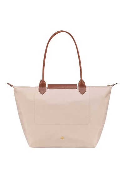 Beige tote bag made of smooth fabric with brown leather handles and accents, featuring a front pocket and gold zipper detail.