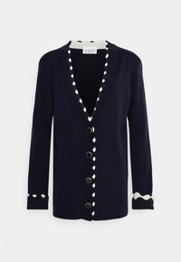 Marinblå cardigan med v-formad hals, krämfärgad scallop-detalj, guldfärgade knappar, långa ärmar och ribbade detaljer vid ärmsluten. Mjukt stickat material.