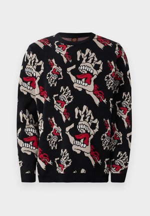 Knit sweater featuring a black background with repeating patterns of skulls and hands in shades of beige, red, and white. Classic crew neck design.