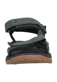 Gröna tygremmar sandaler med en svart texturerad fotbädd, gummisula och justerbara Velcro-stängningar för en säker passform.