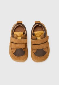 Brown suede and mesh toddler shoes with two Velcro straps, round toe, and flexible rubber soles. Accented with a brown logo on the tongue.