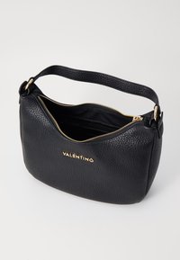 Black leather shoulder bag with a textured surface, gold zipper, and embossed logo. Curved shape and single strap for easy carrying.