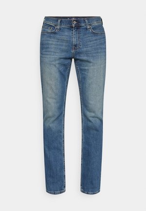 Blaue Jeans aus Denim mit geradem Bein, ausgestattet mit einem klassischen Five-Pocket-Stil, Knopfverschluss und subtilen Ausbleichungen im Stoff.