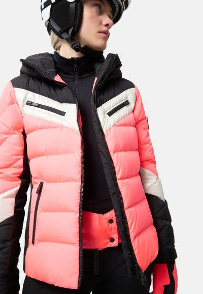 Puffy ski jacket in vibrant pink, black, and white, featuring zippered chest pockets, a fitted hood, and textured puffs for insulation.