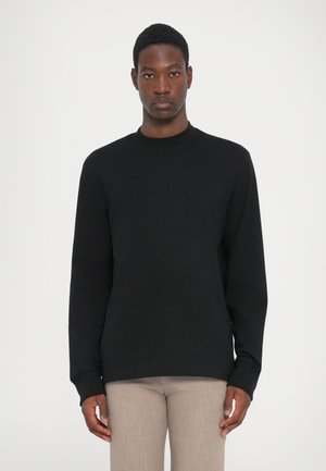Black long-sleeve sweatshirt with a crew neckline. Smooth cotton fabric, fitted cuffs, and a relaxed silhouette. Simple design, no patterns.
