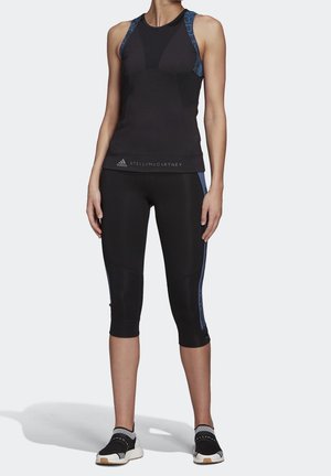 Black athletic tank top with blue patterned straps, paired with black capri tights featuring blue side accents and black running shoes.