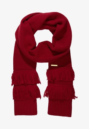 Écharpe en maille rouge profond avec deux franges superposées à chaque extrémité et une petite étiquette logo rectangulaire en or.