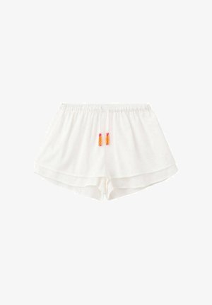 Witte shorts met elastische taille, gelaagde zoom en oranje-roze koordkwastjes aan de voorkant in het midden.