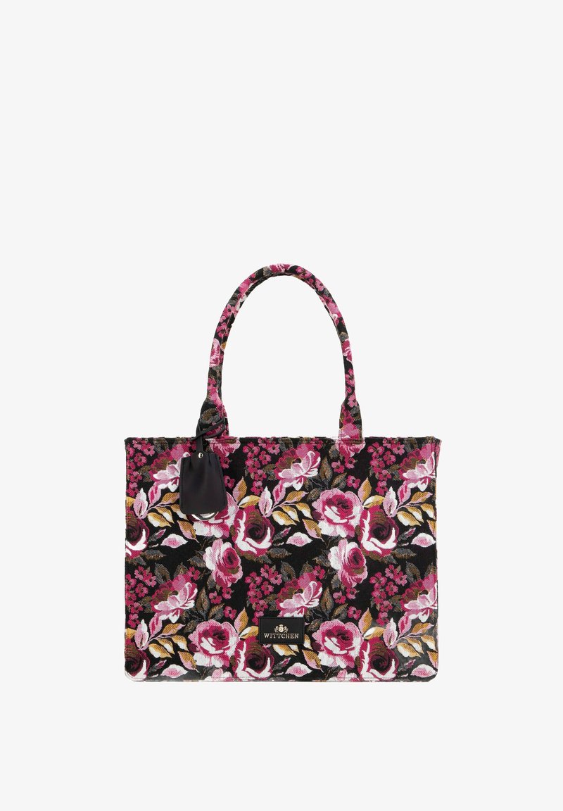 Květinová taška s černým pozadím, zdobená růžovými a zlatými květy, texturovaná tkanina a dvě pevné rukojeti. Obsahuje černou koženou štítku.