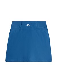 Blå idrottskjol gjord av mjukt tyg. Har en framficka med dragkedja och en logotyp på midjebandet. Rakt snitt med rena kanter.